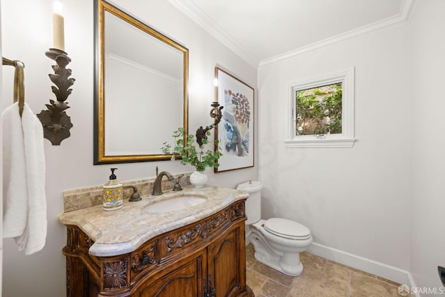 bathroom with toilet, vanity, baseboards, stone finish flooring, and crown molding