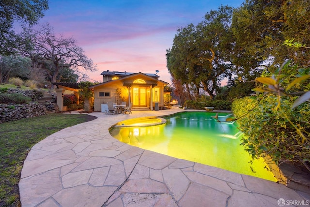 outdoor pool with a patio area