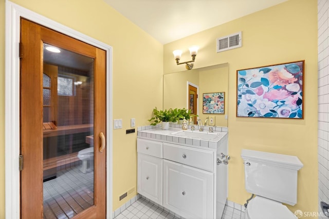 bathroom featuring toilet, tile patterned flooring, visible vents, and vanity