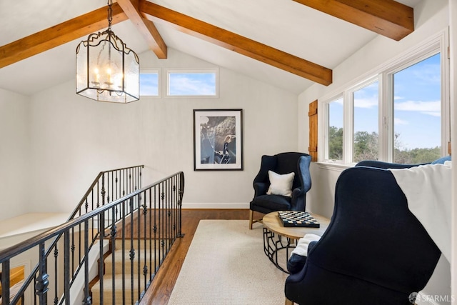 living area featuring vaulted ceiling with beams, a chandelier, wood finished floors, and an upstairs landing