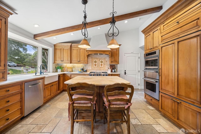 kitchen featuring stone tile floors, premium range hood, a sink, light countertops, and stainless steel dishwasher