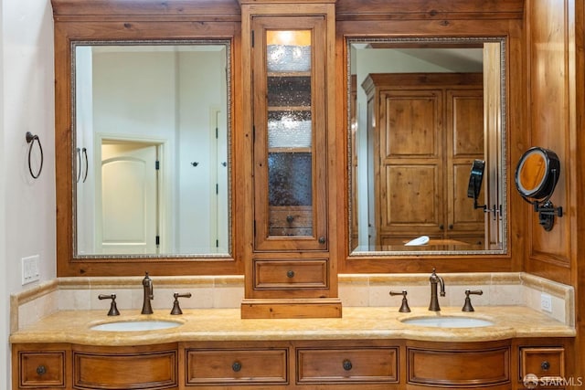 full bath with a sink and double vanity