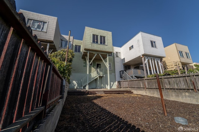 262 Topeka Ave, San Francisco, CA 94124 - back of property featuring mansard roof, fence, and stairs
