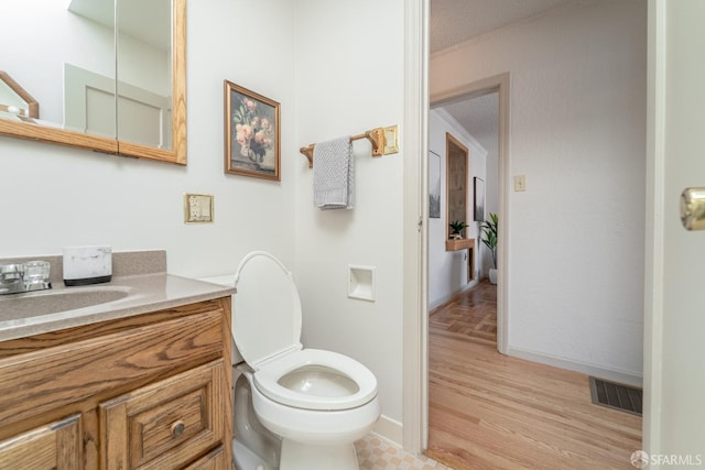 262 Topeka Ave, San Francisco, CA 94124 - bathroom with vanity, toilet, wood finished floors, and baseboards