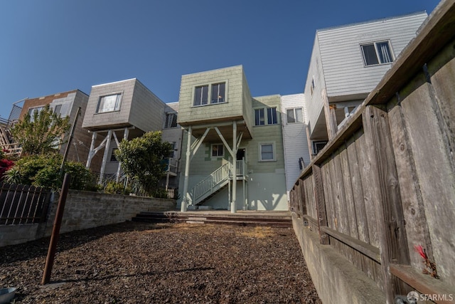 262 Topeka Ave, San Francisco, CA 94124 - back of house with fence, stairway, and mansard roof