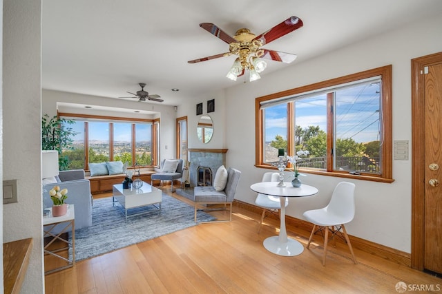 66 Baldwin Ave, Crockett, CA 94525 - living area with wood finished floors, a ceiling fan, and a fireplace