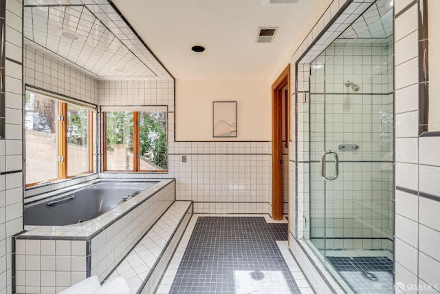 66 Baldwin Ave, Crockett, CA 94525 - bathroom with tile walls, a stall shower, a garden tub, and tile patterned flooring
