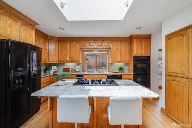 66 Baldwin Ave, Crockett, CA 94525 - kitchen featuring black appliances, backsplash, light stone counters, light wood-style flooring, and recessed lighting