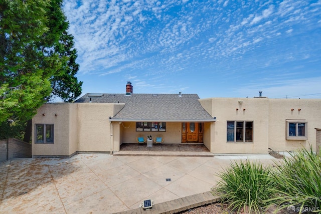 66 Baldwin Ave, Crockett, CA 94525 - rear view of house featuring stucco siding, a chimney, roof with shingles, and covered porch