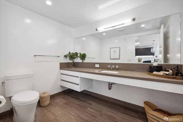 bathroom with toilet and vanity