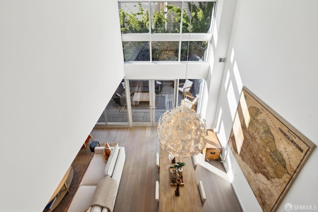 interior space featuring hardwood / wood-style flooring and a towering ceiling