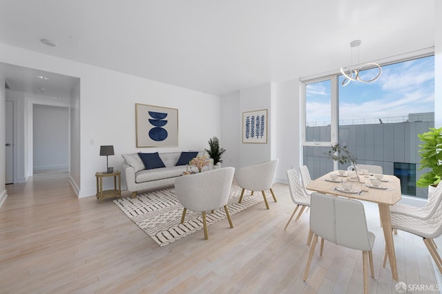 living room featuring light hardwood / wood-style floors and a notable chandelier