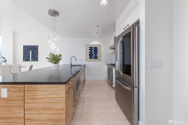 kitchen with light hardwood / wood-style floors, sink, white cabinets, hanging light fixtures, and stainless steel appliances