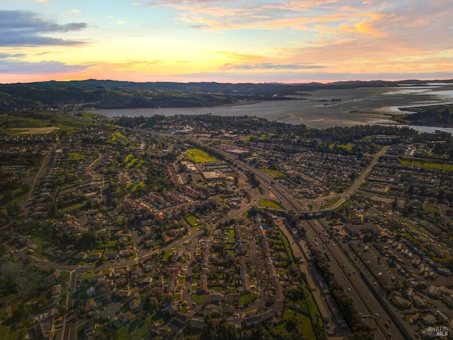 aerial view at dusk with a water view