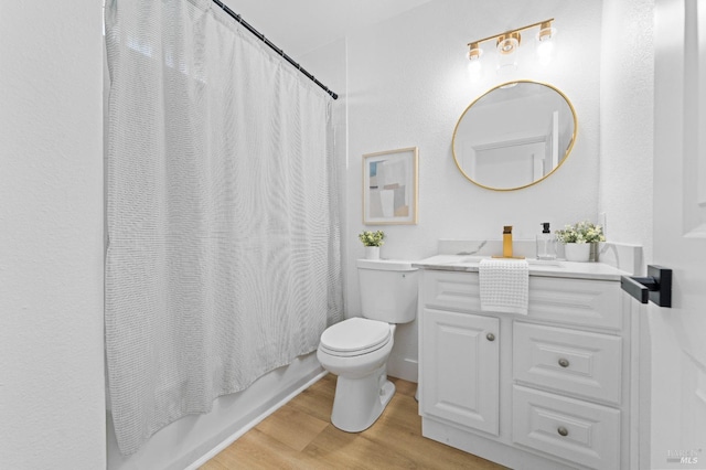 bathroom with shower / bath combo with shower curtain, vanity, toilet, and wood finished floors