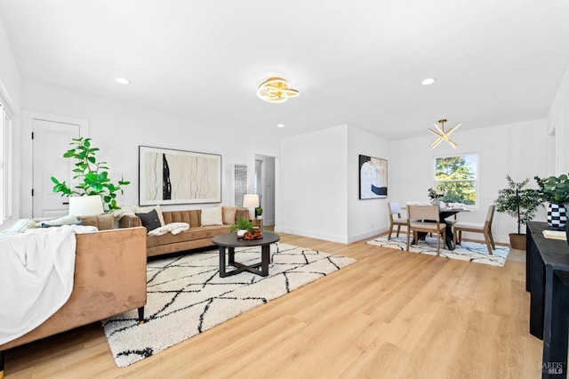 living area featuring baseboards, recessed lighting, and light wood-style floors