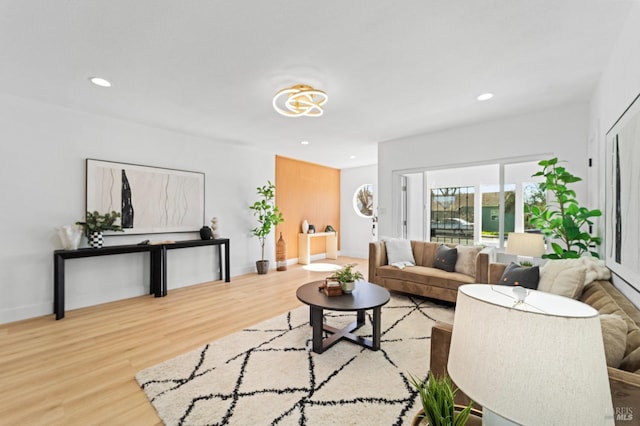 living room with baseboards, wood finished floors, and recessed lighting