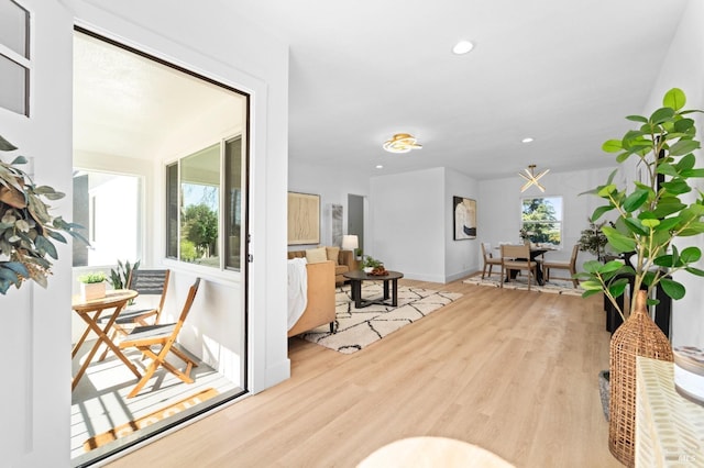 interior space with baseboards, wood finished floors, and recessed lighting