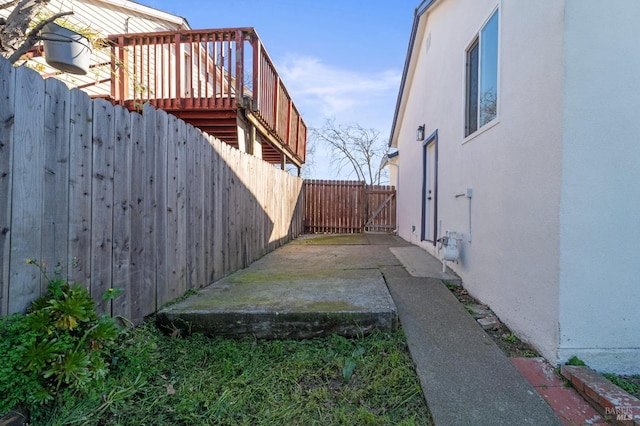 view of property exterior with a patio, fence, and stucco siding