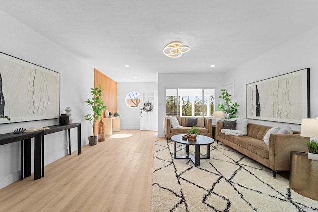 living area featuring recessed lighting, baseboards, and wood finished floors