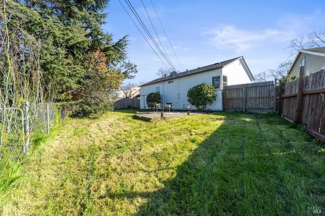 view of yard featuring a patio area and a fenced backyard