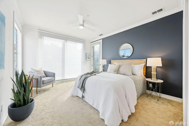 bedroom featuring light carpet, multiple windows, visible vents, and ornamental molding