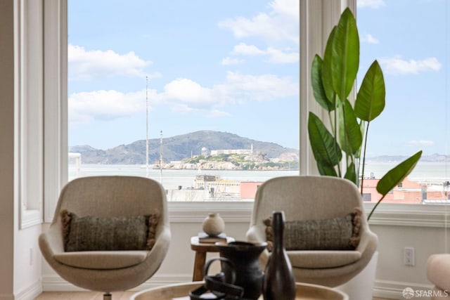 living area with baseboards and a mountain view