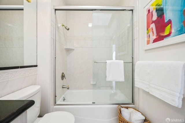 full bathroom featuring toilet, enclosed tub / shower combo, and vanity