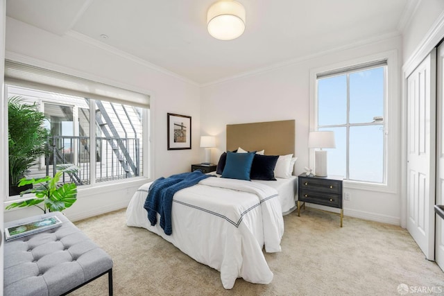 bedroom featuring light carpet, ornamental molding, and baseboards