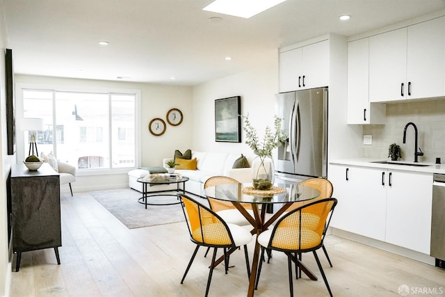 dining space with recessed lighting and light wood-style floors