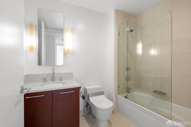 full bathroom featuring toilet, shower / bath combination with glass door, and vanity