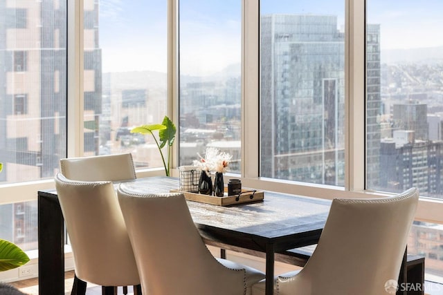 dining room with a view of city and plenty of natural light