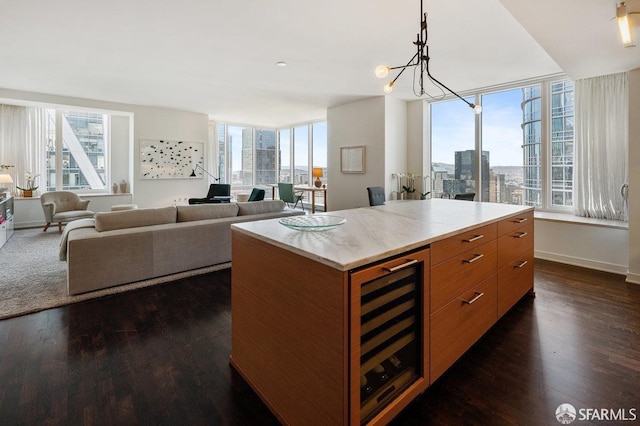 kitchen with wine cooler, a city view, dark wood-type flooring, light countertops, and brown cabinetry