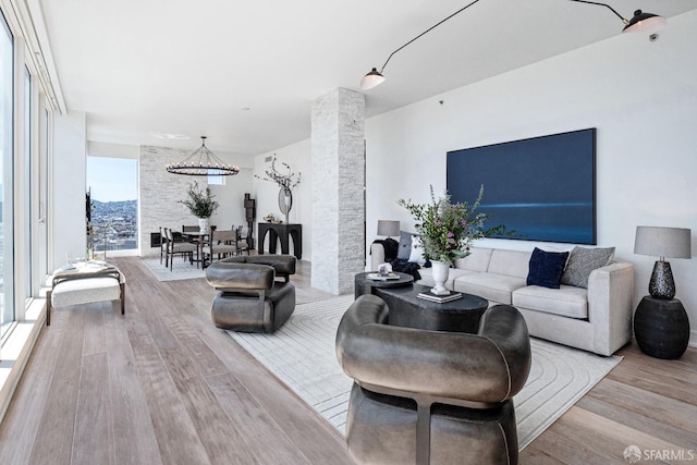 living room with light wood-type flooring and plenty of natural light