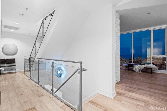 hall featuring expansive windows and hardwood / wood-style floors