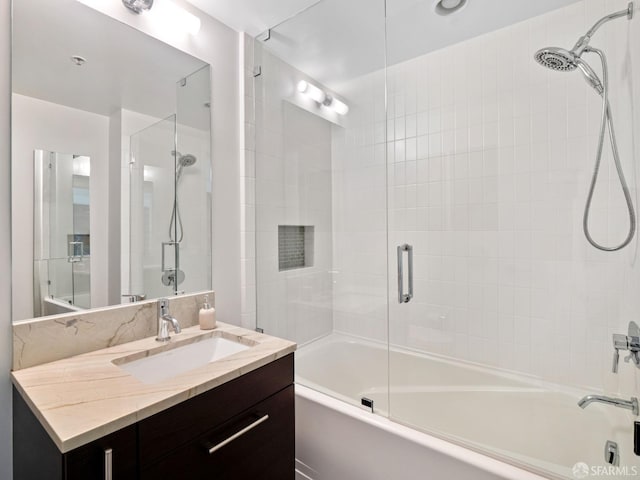 bathroom with enclosed tub / shower combo and vanity