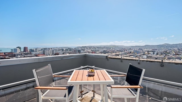 balcony featuring a water and mountain view