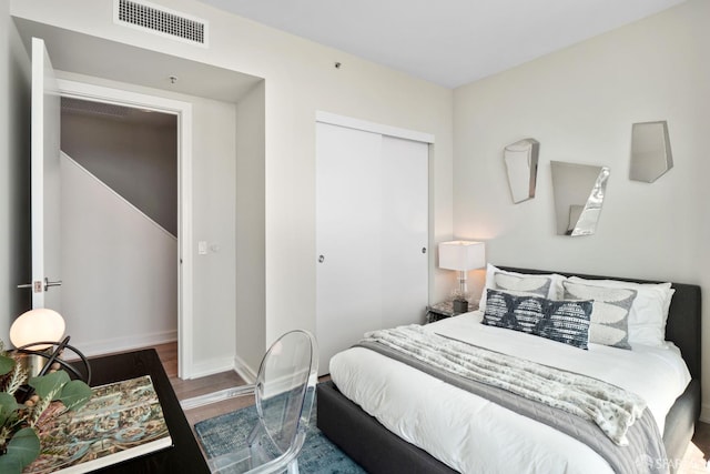 bedroom featuring dark wood-type flooring and a closet