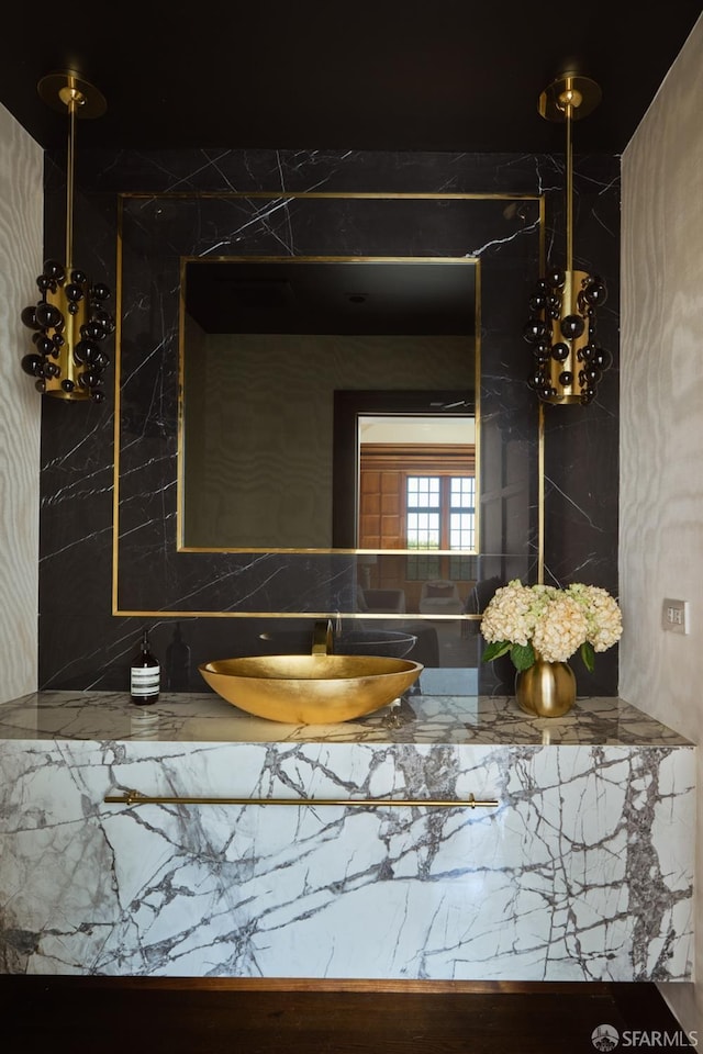 bathroom with a sink and backsplash
