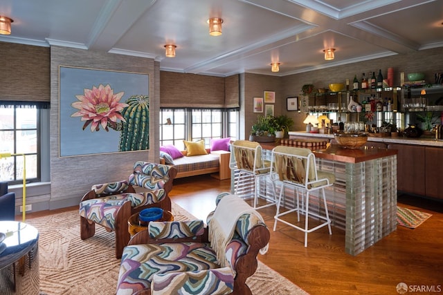interior space featuring crown molding, bar area, beam ceiling, and wood finished floors