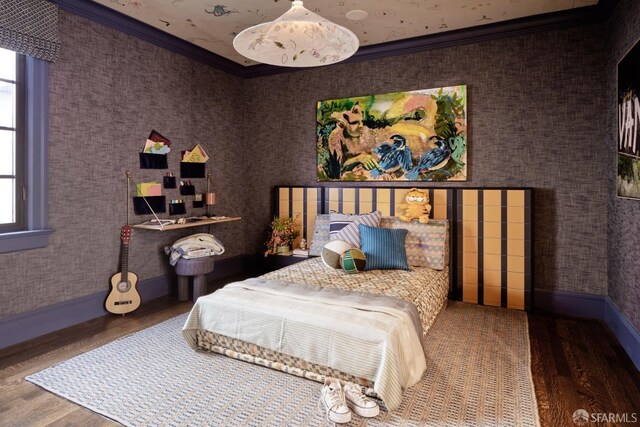 bedroom with baseboards, wood finished floors, and ornamental molding