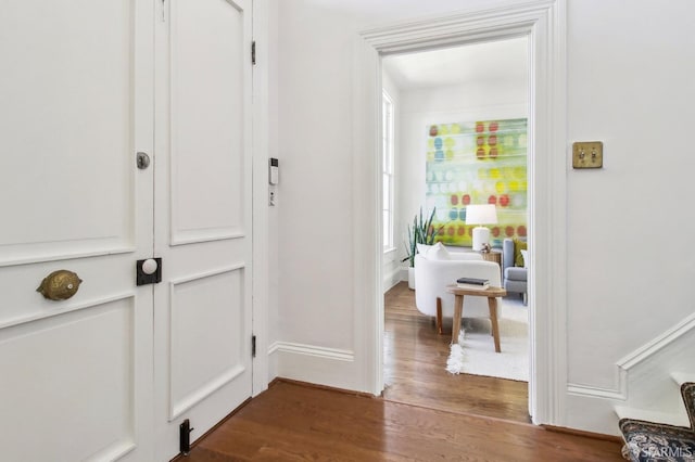 hall with hardwood / wood-style floors