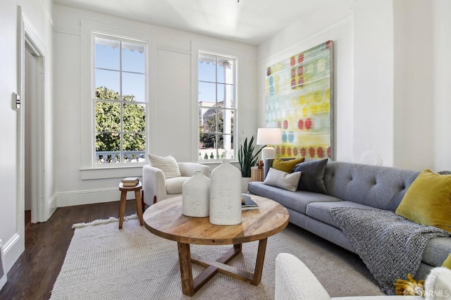 sitting room with dark wood-type flooring