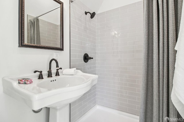 bathroom with curtained shower and sink