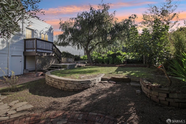 yard at dusk with a wooden deck