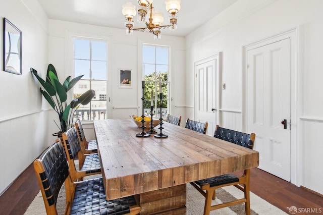 dining room featuring dark hardwood / wood-style floors and an inviting chandelier