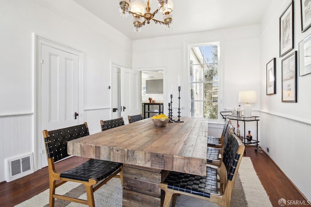 dining room featuring a chandelier and dark hardwood / wood-style flooring