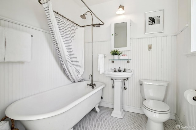 bathroom with shower / bath combo and toilet