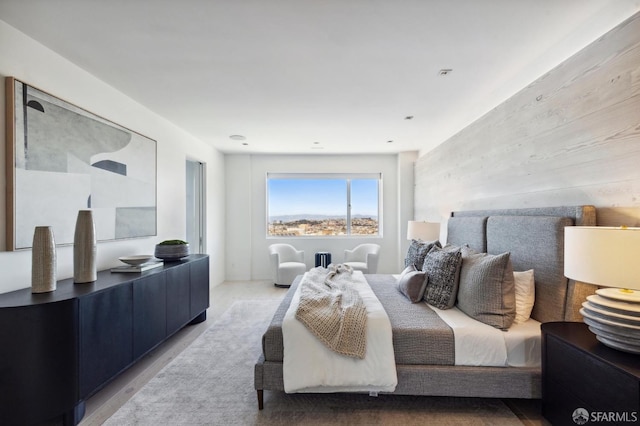 bedroom featuring wooden walls