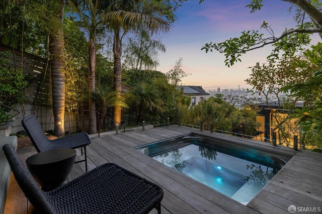 pool at dusk with a deck